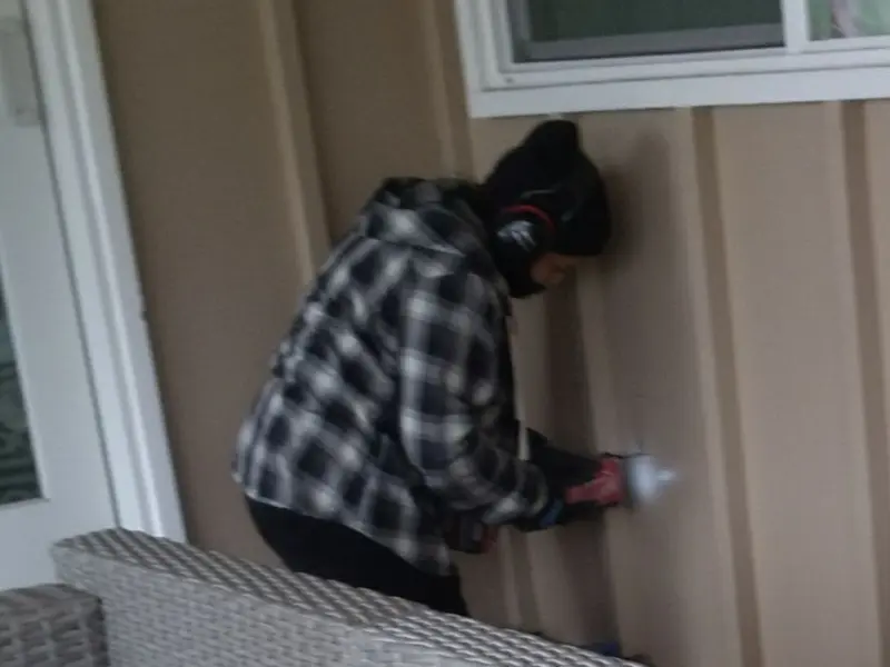 Professional electrician installing an exterior outlet in Cambridge